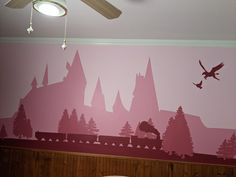 a bedroom with a large mural on the wall