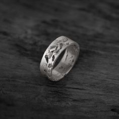 ◆ DIMENSIONS ◆ Ring: 8 x 1,5mm // 0,31" x 0,06" ◆ MATERIAL & TECHNIQUE ◆ Solid 925 sterling silver, cast in sand. This wide textured band is part of our "EMBRACING CHAOS" collection, a tribute to life itself. The unexpected is around every corner, and about to happen... It is our aim to embrace this chaos and the imperfections in it, and our jewelry is a representation of it. Because each ring is cast in sand individually in our Berlin studio, there are no two of the same. By using a wide variet Minimalist Etched Jewelry For Promise, Minimalist Etched Promise Jewelry, Etched Round Band Promise Jewelry, Rustic Wedding Bands, Black Wrapping Paper, Stamp Maker, Wide Band Rings, Wide Bands, Solid 925 Sterling Silver