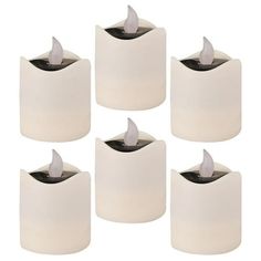 six white candles are sitting next to each other