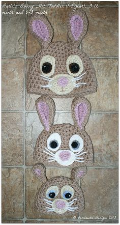 three crocheted bunny ears on top of each other in front of a tile floor