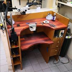 a workbench with many tools on it in a room filled with other items