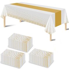 a set of four white and gold polka dot tablecloths with matching napkins