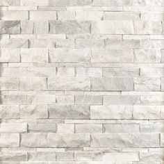 a white brick wall that is made out of stone