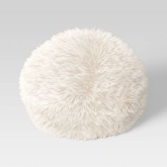 a white fluffy ball sitting on top of a table