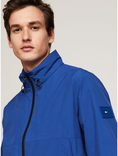 Tommy Hilfiger men's jacket. Our Portland jacket offers superior defense against the elements, all while giving off a classic windbreaker vibe. It's a lightweight, packable, water-resistant layer featuring a breathable outer shell and a bungee cord collar.  Material: 90% Recycled Nylon ,  Polyamide, 10% Recycled Thermoplastic Polyurethane. Tommy Hilfiger Sporty Windbreaker For Streetwear, Tommy Hilfiger Sporty Streetwear Windbreaker, Tommy Hilfiger Windbreaker For Outdoor Fall Activities, Tommy Hilfiger Windbreaker For Fall Outdoor Activities, Tommy Hilfiger Windbreaker For Fall Outdoor, Tommy Hilfiger Casual Outdoor Windbreaker, Tommy Hilfiger Store, Polo Women, Blue Anchor