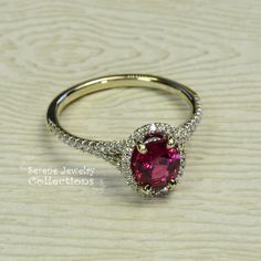 This 18k solid gold Vintage Ring has a sparkly red ruby as its center piece. Diamond rounds decorate a halo around the ruby as well as part of the shank Ring Size: 5.75 Total Weight: 2.87 grams Precious Metal: 18k solid gold Precious stones: -Reddish Orange Sapphire Center Stone: 0.24 carats, 5.7mm x 7.1mm -White Round Diamonds: 0.24 carats Dazzling Oval Ruby Ring, Fine Jewelry Yellow Gold Ruby Ring With Halo Design, Yellow Gold Ruby Rings With Halo Design, Dazzling Oval Ruby Ring With Halo Setting, Heirloom Ruby Ring In Yellow Gold With Halo Design, Heirloom Yellow Gold Ruby Ring With Halo Design, Yellow Gold Ruby Halo Ring For Promise, Yellow Gold Halo Ring With Gemstone, Round Cut, Formal Lab-created Ruby Jewelry With Round Band