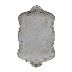 an old silver plate with ornate designs on the edges and sides, isolated against a white background