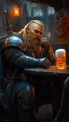 a man sitting at a table with a beer in his hand