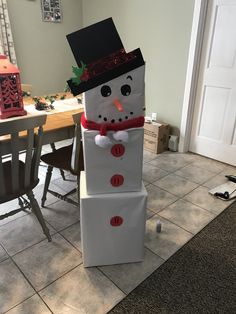 a snowman made out of boxes sitting on the floor