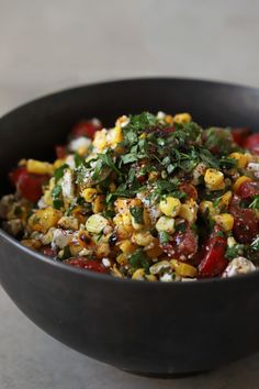 a black bowl filled with food on top of a table