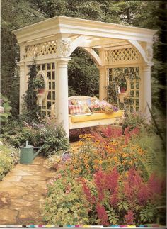 an image of a gazebo in the garden with flowers and plants growing around it