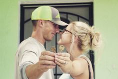 a man and woman holding keys to each other