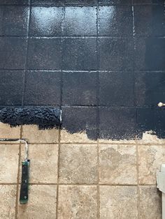 a tile floor with black paint on it