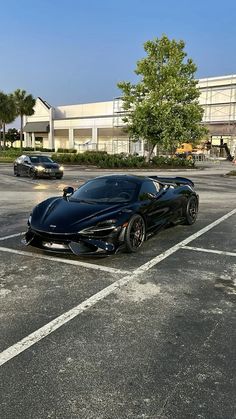 a black sports car parked in a parking lot