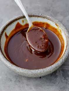 a spoon in a bowl filled with melted chocolate