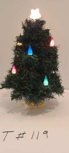 a small christmas tree sitting on top of a table