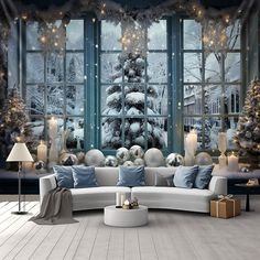 a living room decorated for christmas with large windows and snow - covered trees in the background