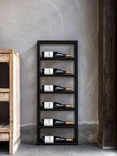 a wine rack sitting next to a wooden cabinet