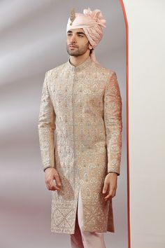 Top Details Color- Peach, Fabric - Soft Blended Silk With Embroidered Bottom Details Color- Peach, Fabric - Dhupion Silk, Style - free size churidar Package Include :INCLUDES 1 SHERWANI,1 CHUDIDAR. Turban ,Mojari And Other Accessories Are Not Sold Along With The Dress. CARE: DRY CLEAN ONLY Additional Information : - As This Sherwani/Waistcoat/Kurta Are Made As Per Orders So It Is Strictly Not Acceptable Once Get Delivered .So Kindly Choose Body Fit Size . Also We Keep 2 Inches Extra Margin In Th Embroidered Jamawar Sherwani For Wedding, Wedding Jamawar Kurta With Embroidery, Long Embroidered Bandhgala For Ceremonial Events, Embroidered Brocade Sherwani For Reception, Eid Wedding Sherwani With Resham Embroidery, Traditional Bandhgala With Zari Work For Reception, Traditional Nehru Jacket With Intricate Embroidery For Wedding, Embroidered Sherwani For Reception And Transitional Season, Embroidered Sherwani For Reception During Transitional Season