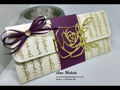 a white and purple card with a rose on it