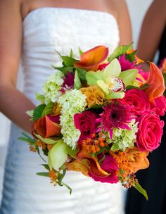 a bride holding a bouquet of flowers in her hands