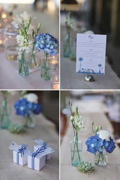 blue and white flowers in glass vases on a table with cards, candles and napkins