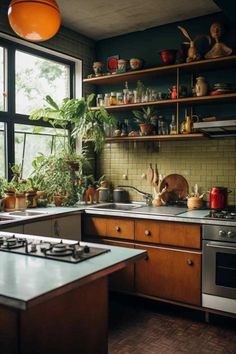 a kitchen with lots of pots and pans on the shelves above the stove top