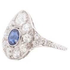 Year: 1926 (Engraved on shank) Item Details: Ring Size: 5.25 Metal Type: Platinum [Hallmarked, and Tested] Weight: 3.7 grams Center Stone Details: GIA Report#:2235156476 Weight: .60ct total weight Cut: Old European brilliant Color: Blue Type: Natural, Unheated Diamond Details: 1.00ct, total weight. F Color, VS Clarity, Old Mine Brilliant, Natural. Finger to Top of Stone Measurement: 4mm Shank/Band Width: 2.0mm Condition: Excellent Price: $3000 Vintage Platinum Ring With Gemstone, Antique Platinum Ring With Gemstone, Vintage Sapphire Ring With Diamond Cut, Oval Shape, Antique Platinum Gemstone Rings, Vintage Oval Sapphire Ring With Diamond Cut, Antique Platinum Rings With Gemstone, Collectible Art Deco Platinum Sapphire Ring, Art Deco Oval Sapphire Ring In Platinum, Vintage Oval Sapphire Ring In Platinum