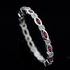 a white gold ring with pink sapphires and diamonds