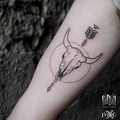 a bull's head with an arrow and arrows on the side of his arm