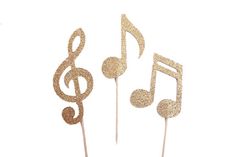 three gold musical notes on top of each other with music staffs in the middle