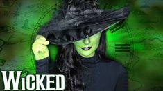 a woman wearing a witches hat and green makeup with the words, wicked on it