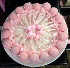 a cake decorated with pink and white candies