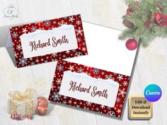 two red and white snowflaked christmas name tags on top of each other