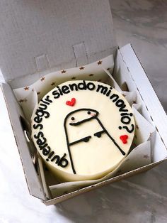 a white cake in a box with the words sorry, stenomink com on it