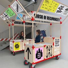 two people sitting at a booth with signs on it