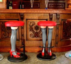 two stools with legs that have red and white heels on them