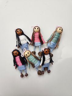 four dolls are arranged in the shape of a circle