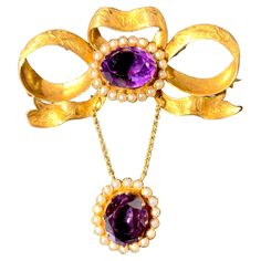 This fine brooch is designed as a bow tied out of an engraved gold ribbon decorated with an oval facetted Russian amethyst mounted in a gold frame set with oriental pearls. Another amethyst, also mounted with natural oriental pearls, is suspended from two gold chains attached to the bow. The jewel is stamped with Russian hallmarks for 14 karat gold. Jewellery Vintage, Bow Brooch, Antique Brooches, Gold Ribbon, Gold Ribbons, Frame Set, Antique Jewellery, Gold Frame, Gold Chains