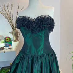 "1980's Laura Ashley Emerald Green Strapless Rose Dress Absolutely dreamy 80's strapless dress that screams of 1980's Princess Diana style. Simple cut in a Glowing emerald green fabric. While the bodice fabric doesn't have a print, the fabric on the skirt has a subtle rose design in a a matte black that matches the bust line matte black frills. Measurements provided are flat and have been doubled. Vintage 1980's size 12 Bust 34\" Waist 30\" Hips free\" Length 52.5\" ❤️ Condition: Excellent vinta Green Ruffled Strapless Party Dress, Green Ruffled Strapless Dress For Party, Green Strapless Dress With Ruffles For Party, Green Strapless Ruffle Dress For Party, 80’s Prom Dress, Princess Diana Style, Emerald Green Fabric, Diana Style, Heart Blouse