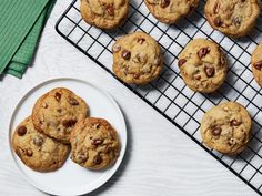 chocolate chip cookies on a cooling rack next to a plate