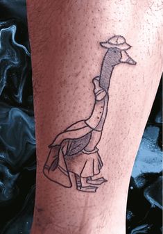 a tattoo on the leg of a man with a giraffe in it's head