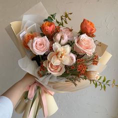 a person holding a bouquet of flowers in their hand