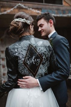 a bride and groom embracing each other in front of a building