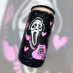 a black and pink can with a phone on it