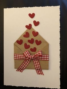 an envelope decorated with hearts and ribbon