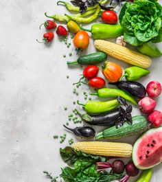 many different types of fruits and vegetables on a white surface with space for text or image