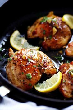 chicken thighs with lemons and parsley in a cast iron skillet