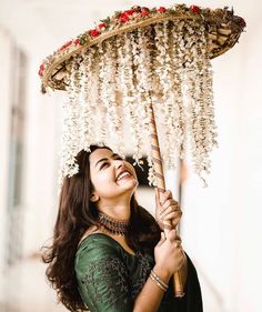 a woman is smiling while holding an umbrella