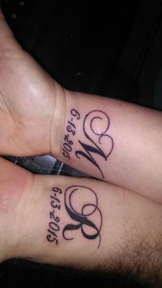 two people with matching tattoos on their arms, one has the word love written in cursive writing